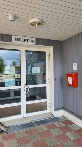 a door to a store with a registration sign on it at Youth Center Vasatokka in Inari