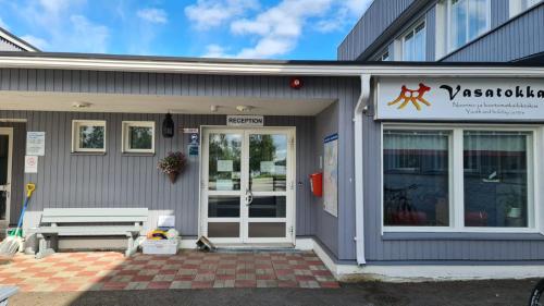 a building with a bench in front of it at Youth Center Vasatokka in Inari