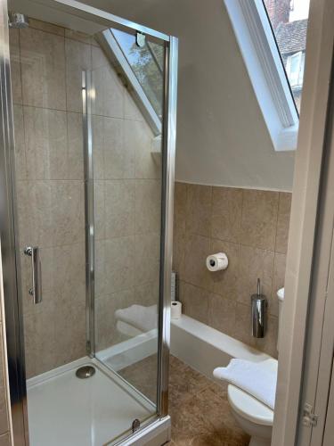 a bathroom with a shower and a toilet at The Kings Arms Inn in Oakham