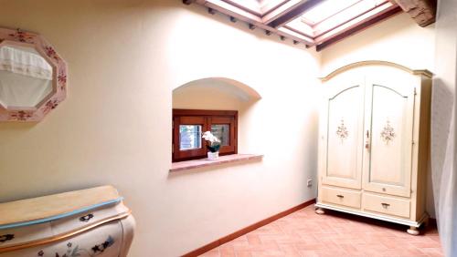 a kitchen with a window and a door in a room at Casa alle Monache in Gambassi Terme