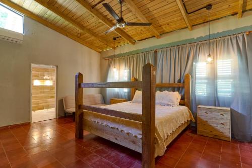 a bedroom with a wooden bed with a wooden ceiling at Casa Kafe in Cabrera