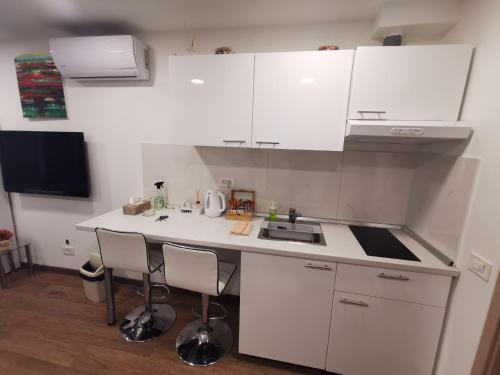 a small kitchen with white cabinets and a sink at Apartment Novi Zagreb in Zagreb