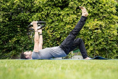 a man doing a push up in the grass at Victoria Jungfrau Grand Hotel & Spa in Interlaken