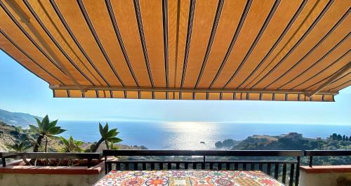 a view of the ocean from the balcony of a house at Blue Marine Taormina in Taormina