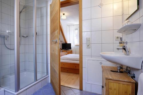 a bathroom with a sink and a shower at Landhotel Schwab - by homekeepers in Schwarzach am Main