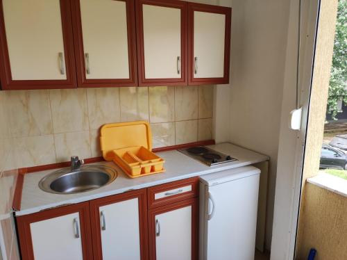 a small kitchen with a sink and a counter top at Sinanovic Rooms in Ulcinj