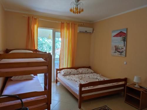 a bedroom with two bunk beds and a window at Sinanovic Rooms in Ulcinj