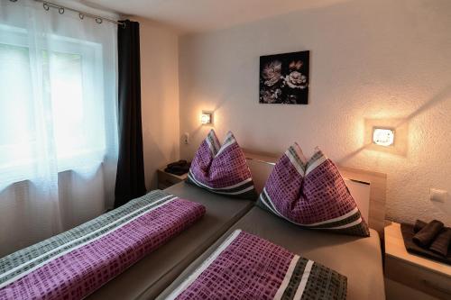 a room with purple pillows on a table with a window at Apartment Nerial in Bruck an der Großglocknerstraße