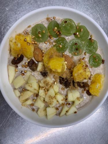 a white plate of food with fruit and nuts at Hôtel Vintage in Quimperlé