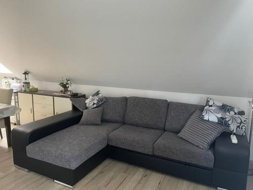 a gray couch in a living room with a table at Apartment 28 in Stadthagen
