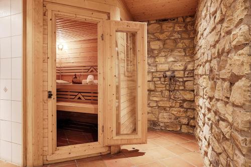 a wooden room with a sauna in a stone wall at Ferienhaus Schwab - Sauna, eigene Terrasse, 3 Schlafzimmer - by homekeepers in Schwarzach am Main