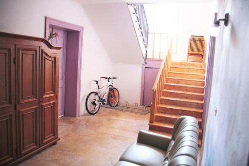 a room with a staircase and a bike in it at Nerezine apartmany CENTRUM in Nerezine