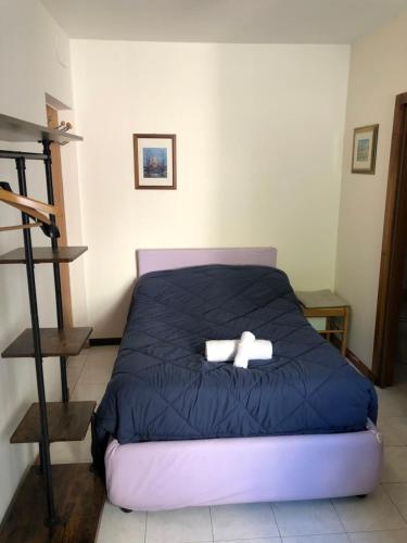 a bedroom with a bed with two white towels at B&B Amico in Comano Terme