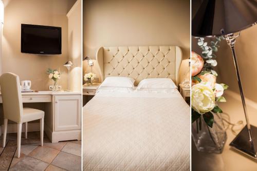 a bedroom with a bed and a desk and a tv at Hotel Savoia in Alassio