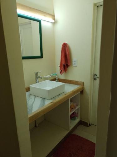 a bathroom with a white sink and a mirror at casa estilo cabaña in Tandil