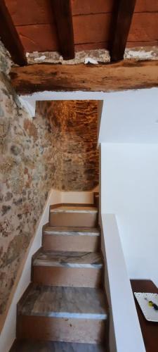 a staircase in an old building with wooden ceilings at Casa del nonno Gino in Pietrasanta