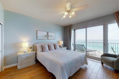 a bedroom with a bed with a view of the ocean at TOPS'L Tides 704 in Destin