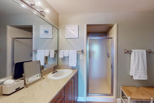 a bathroom with a sink and a shower at TOPS'L Tides 704 in Destin