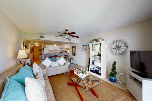 a living room with a couch and a tv at Sugar Beach E5 in Panama City Beach