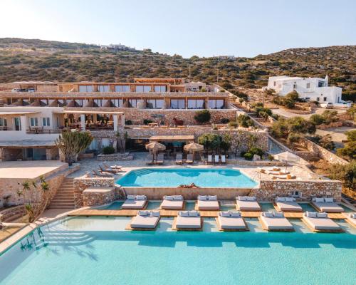 Agia Irini ParosにあるMythic Paros , Adults Onlyのプールとラウンジチェアのあるリゾートのイメージ