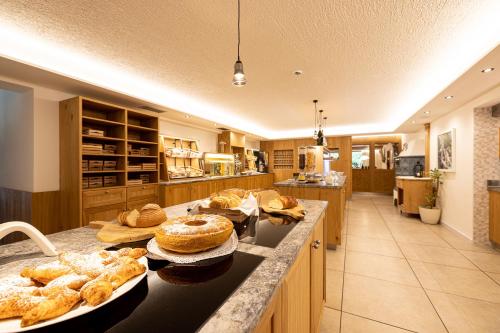 a kitchen with a counter with various pastries on it at Hotel Restaurant Waldheim in Martello