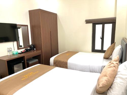 Ένα ή περισσότερα κρεβάτια σε δωμάτιο στο CAT BA ROSALIA HOTEL