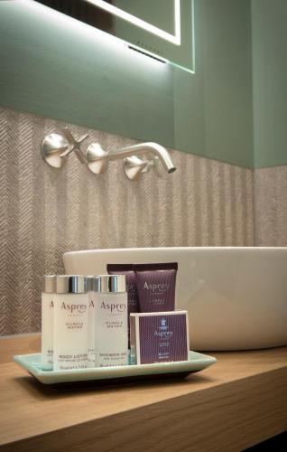 a tray of products sitting on a counter in a bathroom at Relais & Chateaux Hotel Landgoed Het Roode Koper in Ermelo