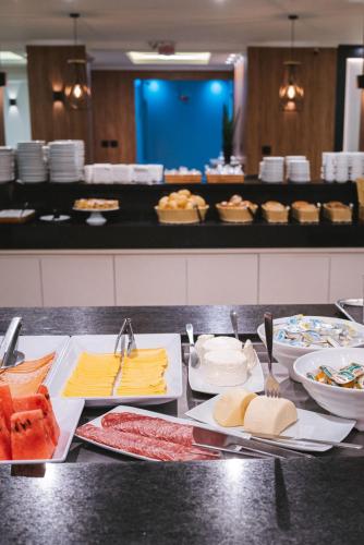 a buffet with cheese and other foods on a counter at Hotel Le Canard Lages in Lages