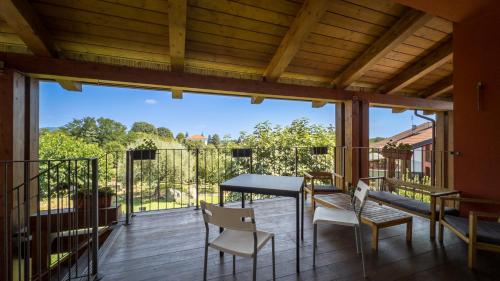 a large deck with a table and chairs on it at Mehdi's home in Pinerolo