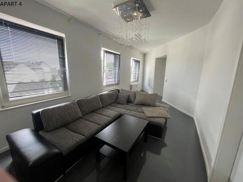 a living room with a couch and a table at Apartment in Solingen Ohligs in Solingen