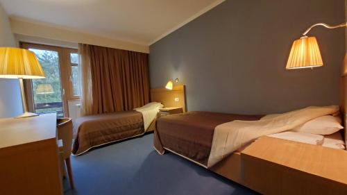 מיטה או מיטות בחדר ב-Hotel Park Ivanjica
