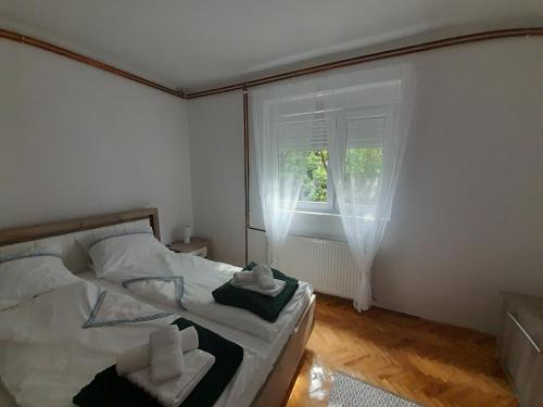 a small bedroom with a bed and a window at Apartman Stevan in Pirot