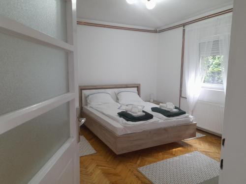 a bedroom with a bed with two towels on it at Apartman Stevan in Pirot