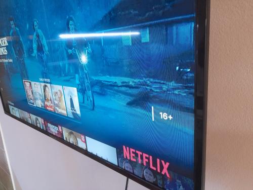 a television screen on a wall with movies on it at Apartman Stevan in Pirot