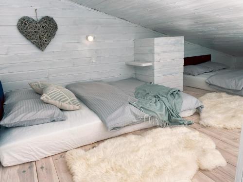 1 dormitorio con 2 camas y 2 alfombras en Wiejskie Swawole-domki w lesie na wsi, 