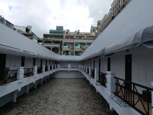 an empty corridor of a building with buildings in the background at 陽明旅館 in Kaohsiung