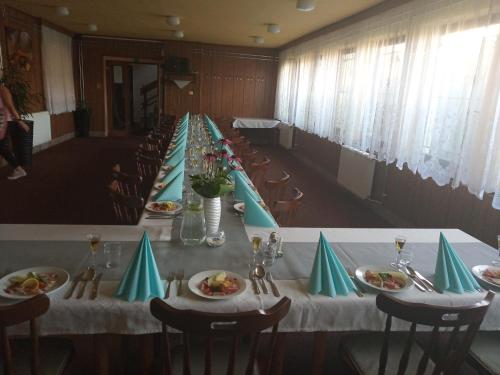 a long table with plates of food on it at Penzión Zátoka in Liptovský Mikuláš