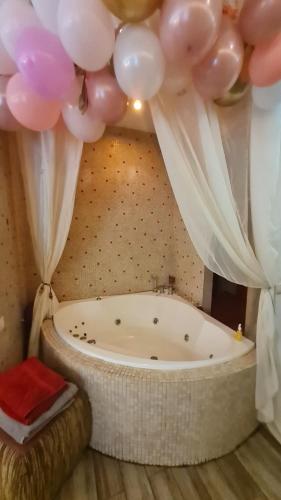 - vasca da bagno in camera con palloncini di Gostauto apartamentai a Vilnius