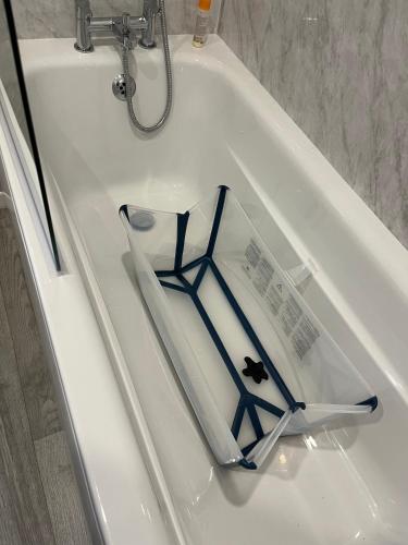 a book sitting on top of a white bath tub at Beach Base Lodge, Padstow Cornwall in Padstow
