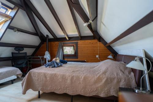a bedroom with a bed in a attic at Lovely house till 6 p. near Amsterdam, Sea in Opmeer