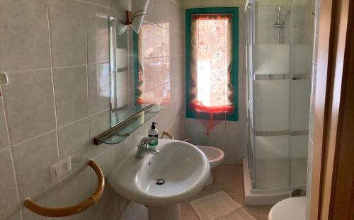 a bathroom with a sink and a toilet and a mirror at ecoVita agri-glamping in San Vito