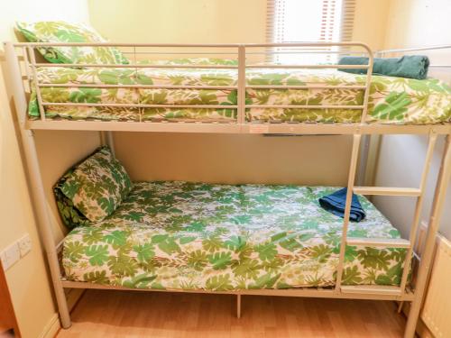 a bunk bed with a couch on the bottom shelf at Marina House in Enniskillen