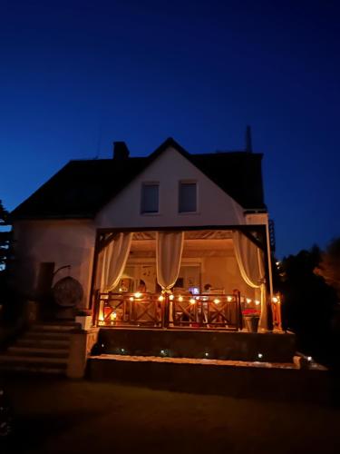 a house with christmas lights on the front door at Zakole Brdy in Gostycyn