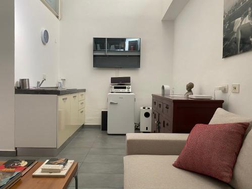 a living room with a couch and a kitchen at Living in Milan