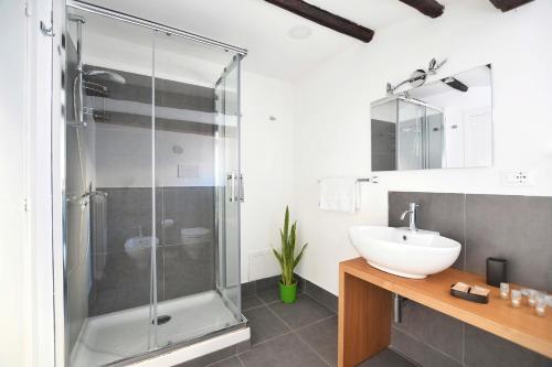 a bathroom with a glass shower and a sink at iFlat Residenza Libertà ai giardini del centro in Palermo