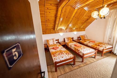 a small room with two beds and a table at SNAM Rooms&Apartment in Žabljak