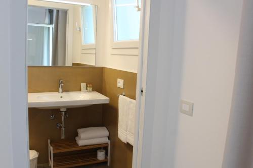 a bathroom with a sink and a mirror at Tennis Rocchette Resort in Castiglione della Pescaia