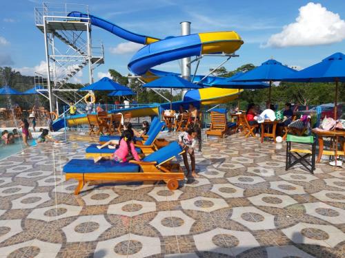 a water park with a water slide and people sitting at Finca Ecoturística Canaguaros in Tauramena