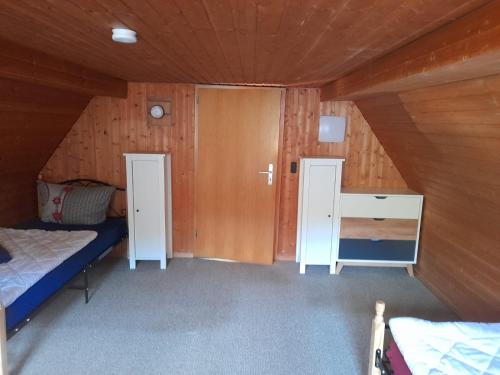 a room with two beds and a desk in a cabin at Haus Guttenberg in Guttenberg