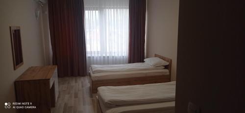 Ένα ή περισσότερα κρεβάτια σε δωμάτιο στο Хотел-ресторант Русаков